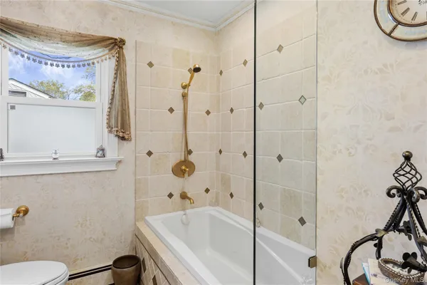 a bathroom with a bathtub and a shower