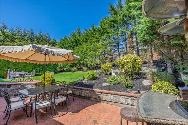 a view of a patio with table and chairs under an umbrella