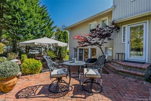 a view of a house with backyard sitting area and garden