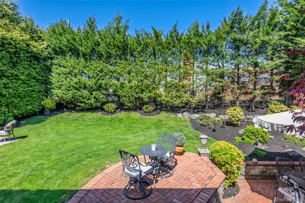 a view of a backyard with sitting area