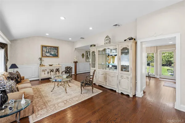 a living room with furniture wooden floor and a large window