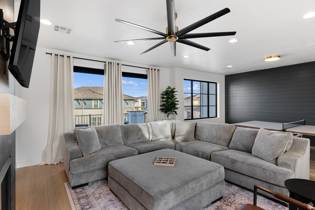 5367 Cyan Lane St. George, UT 84790 - Photo 22 of 49 Spacious living area featuring light wood-finish flooring, a contemporary ceiling fan, recessed lighting, and large windows with privacy curtains