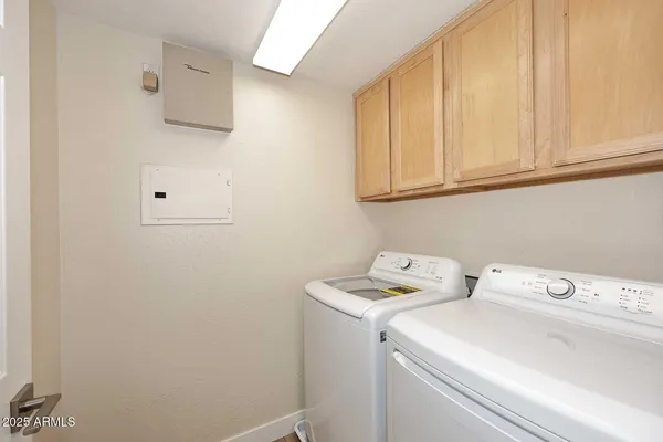 a view of storage and utility room with washer and dryer