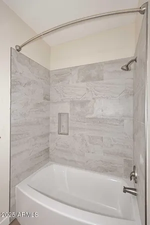a bathroom with a shower and a bath tub
