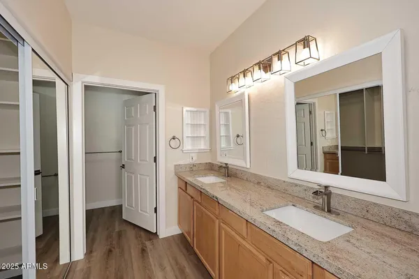 a bathroom with a granite countertop sink mirror and shower