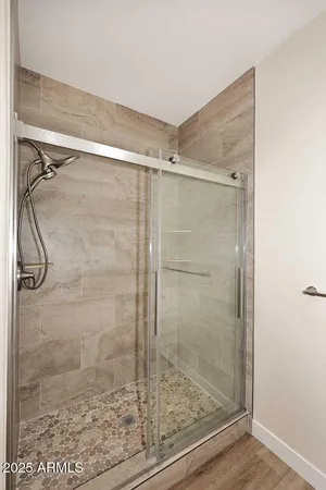 a bathroom with a glass shower door