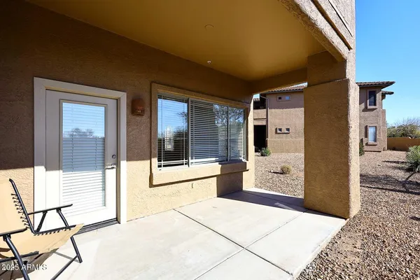 a view of a hallway with dining area and chandelier