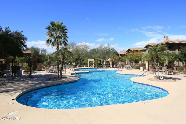 a view of a swimming pool with an outdoor space and seating area