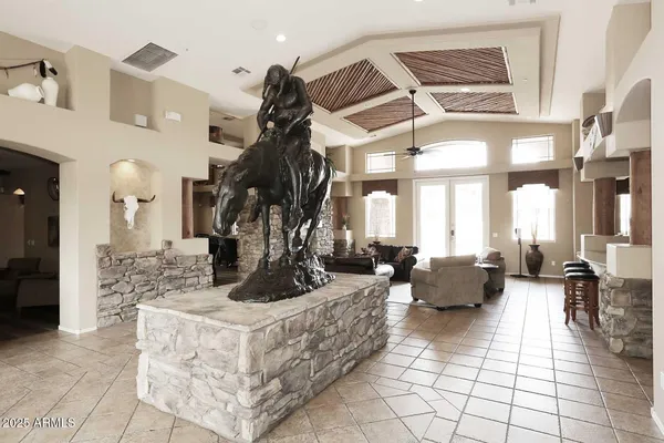 a living room with fireplace furniture and a rug