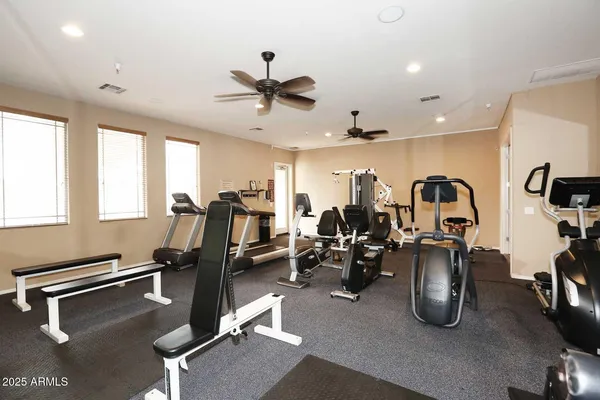 a room with gym equipment and windows