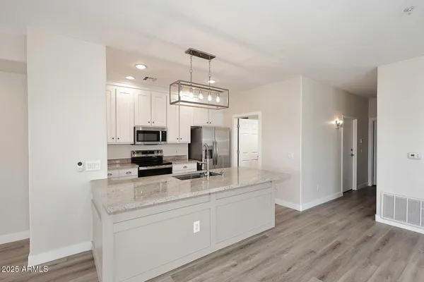 a kitchen with stainless steel appliances a sink stove and refrigerator