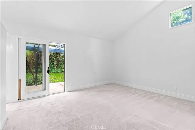 an empty room with an outdoor view and a window