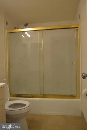 a bathroom with a shower and a toilet