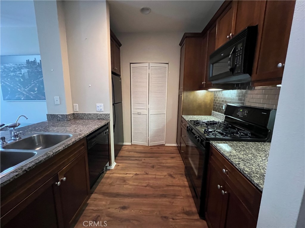 2377 Scholarship Irvine, CA 92612 - Photo 12 of 37 a kitchen with granite countertop stainless steel appliances and wooden cabinets