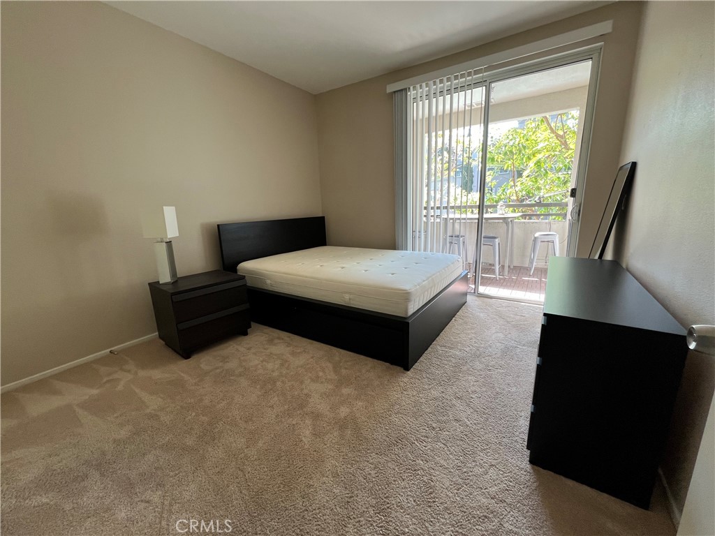 2377 Scholarship Irvine, CA 92612 - Photo 24 of 37 a spacious bedroom with a bed and wooden floor
