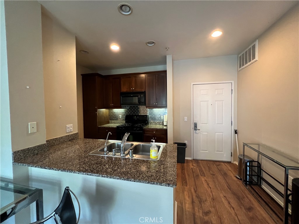 2377 Scholarship Irvine, CA 92612 - Photo 10 of 37 a kitchen with counter top space cabinets and stainless steel appliances