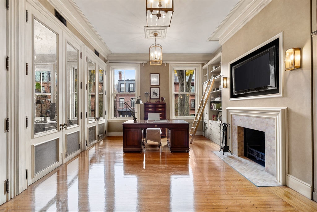 357-359 Beacon Street, Unit 2 Boston, MA 02116 - Photo 6 of 18 a view of a livingroom with furniture fireplace wooden floor and windows