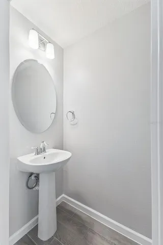 a bathroom with a sink a mirror and vanity