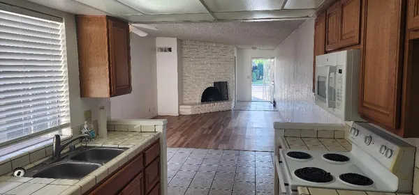 a kitchen with a sink a stove and cabinets