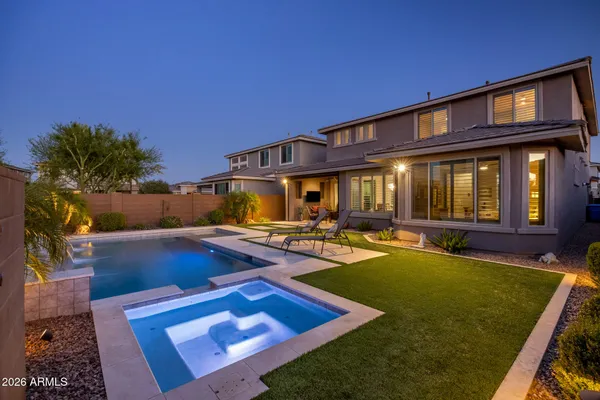 a view of an house with swimming pool patio and outdoor seating