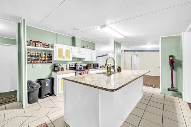 a view of a a dining room with furniture window and wooden floor