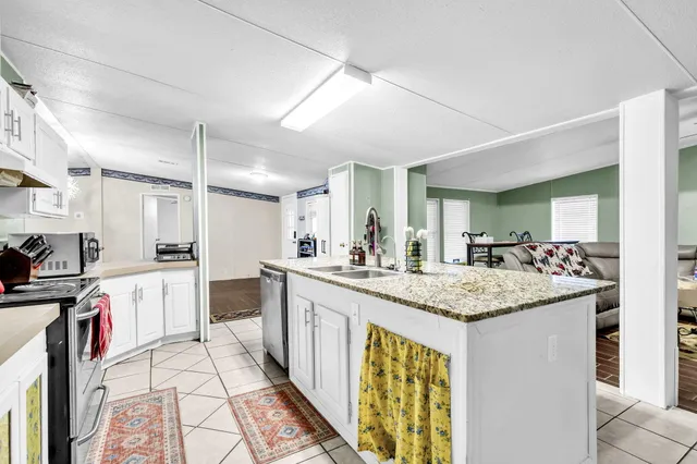 a kitchen with a sink a counter top space and stainless steel appliances