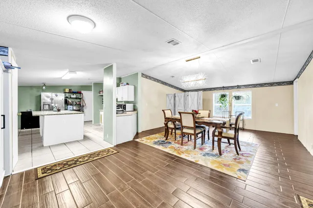 a view of a a dining room with furniture window and wooden floor