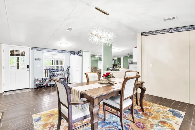 a dining room with furniture and wooden floor