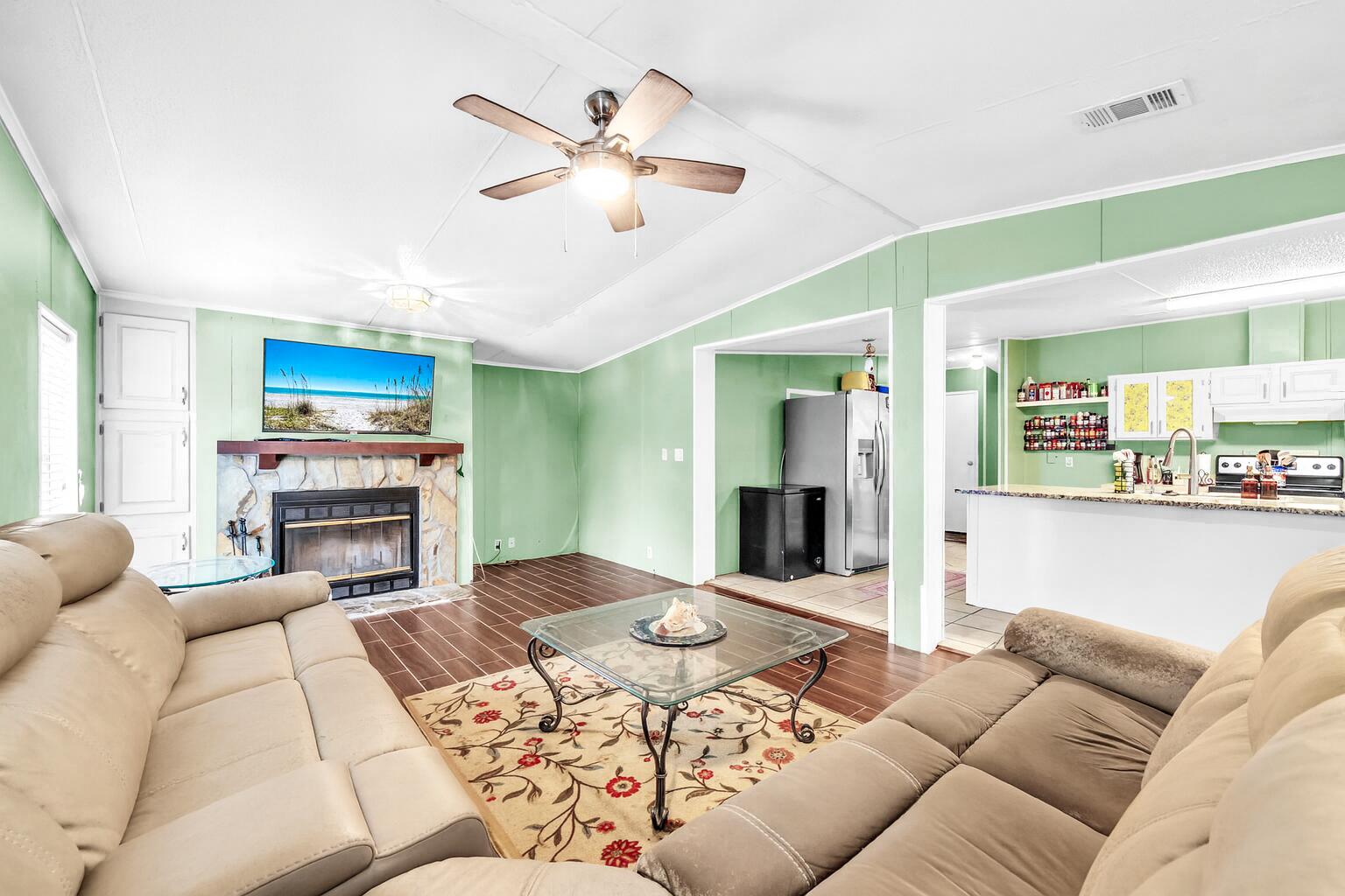 2236 Old Jolly Bay Road Freeport, FL 32439 - Photo 7 of 25 a living room with furniture a fireplace and a flat screen tv