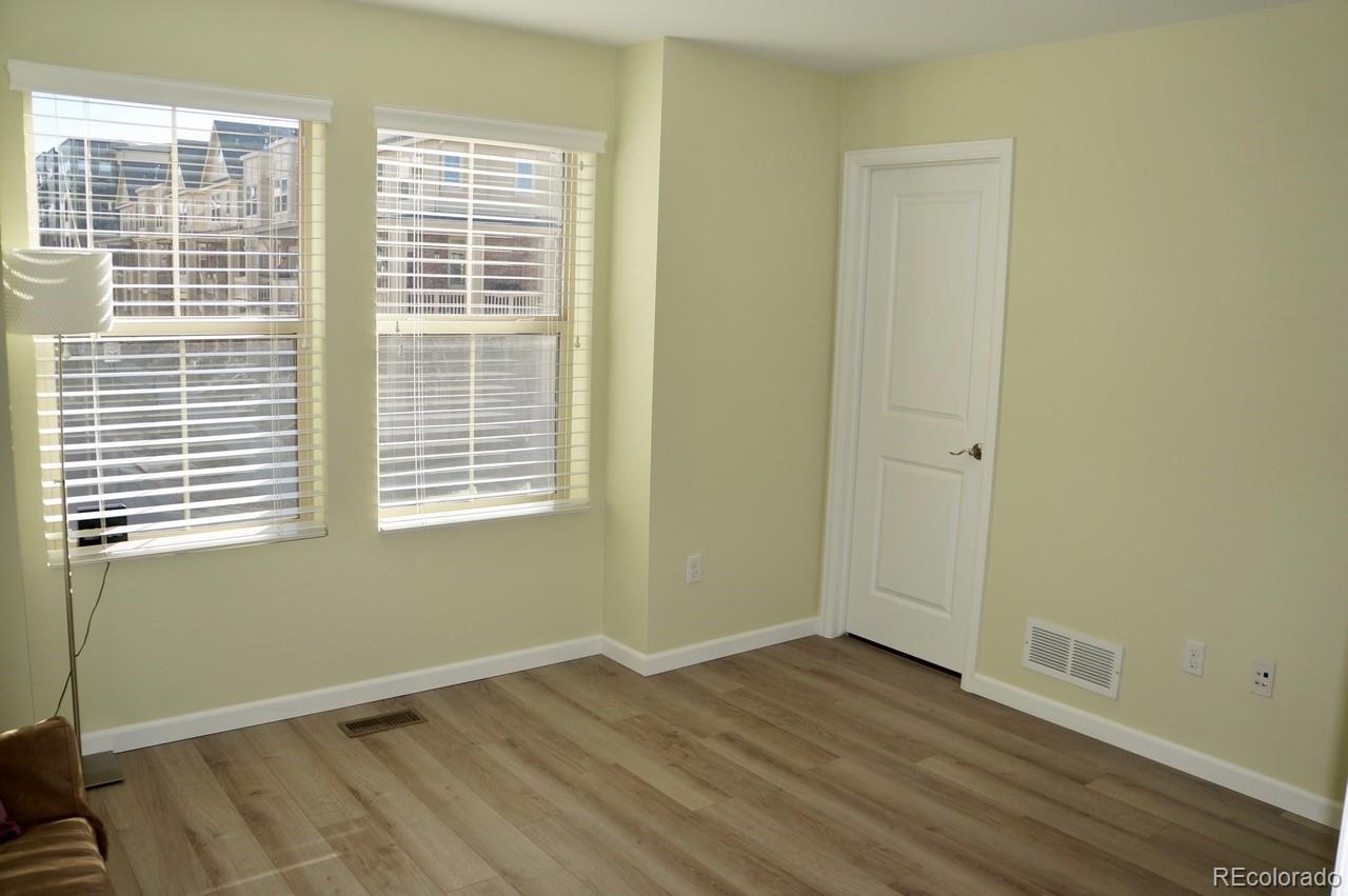 10269 Bellwether Lane Lone Tree, CO 80124 - Photo 12 of 17 a view of an empty room with wooden floor and a window