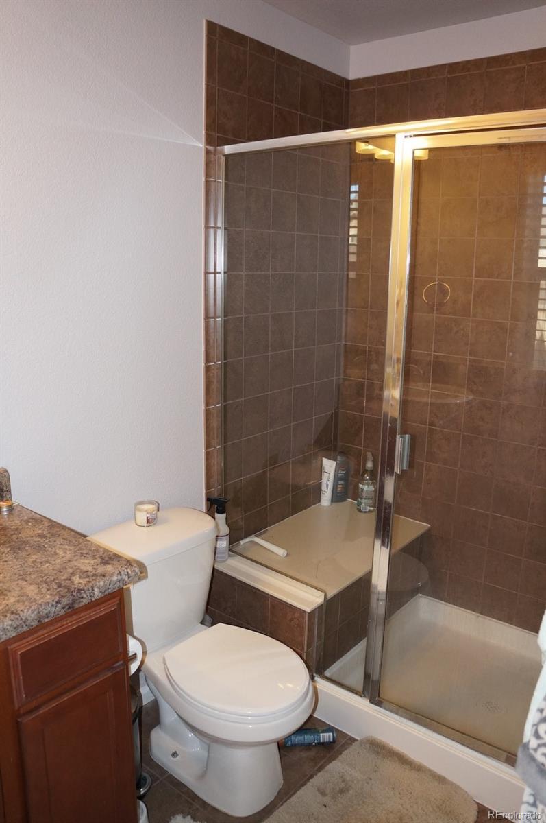 10269 Bellwether Lane Lone Tree, CO 80124 - Photo 14 of 17 a bathroom with a toilet and shower