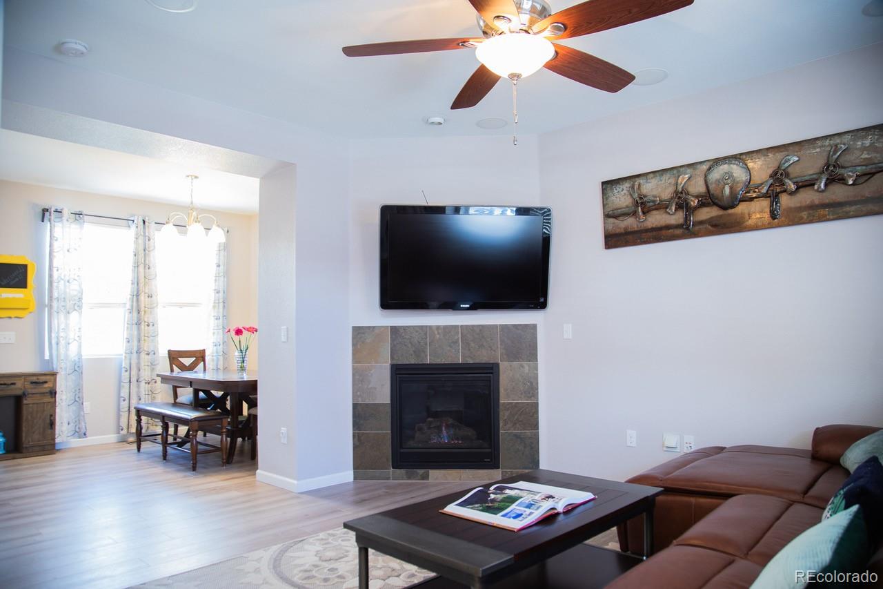 10269 Bellwether Lane Lone Tree, CO 80124 - Photo 4 of 17 a living room with furniture and a flat screen tv
