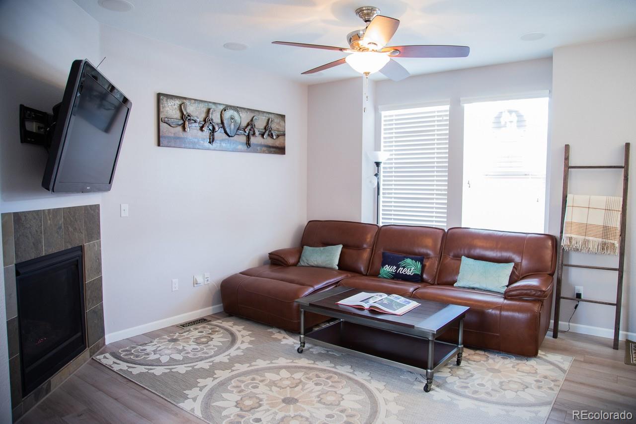 10269 Bellwether Lane Lone Tree, CO 80124 - Photo 5 of 17 a bedroom with a large bed and a fireplace