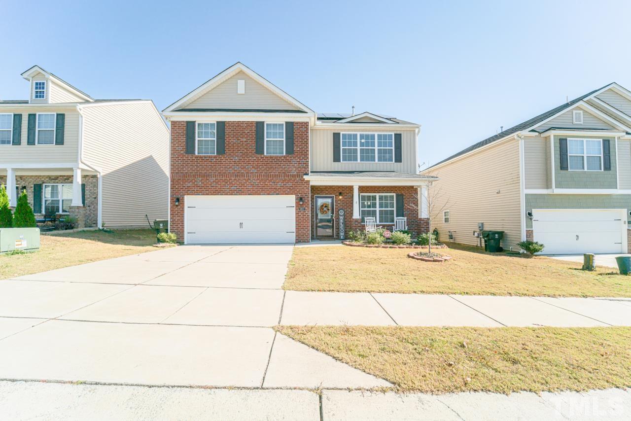 3617 Marble Ridge Lane Raleigh, NC 27610 - Photo 2 of 30 a front view of a house with a yard and garage