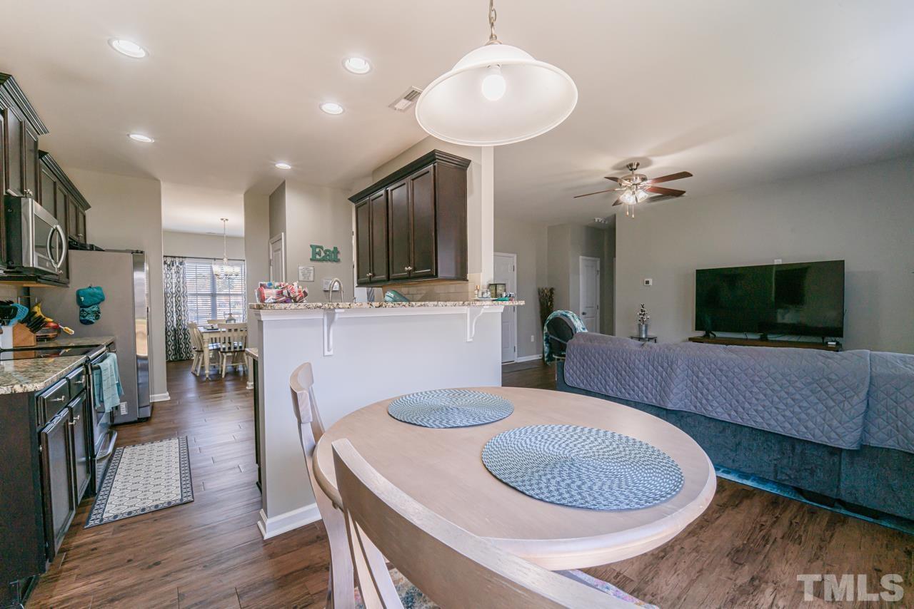 3617 Marble Ridge Lane Raleigh, NC 27610 - Photo 11 of 30 a living room with kitchen island furniture and a flat screen tv
