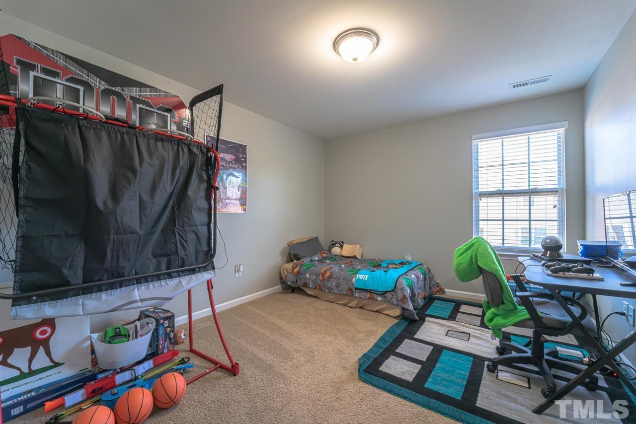 3617 Marble Ridge Lane Raleigh, NC 27610 - Photo 21 of 30 a living room with furniture and a flat screen tv