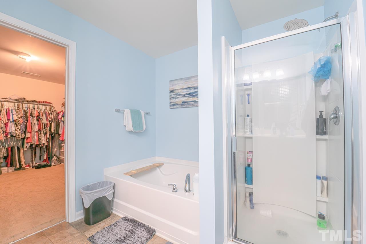 3617 Marble Ridge Lane Raleigh, NC 27610 - Photo 25 of 30 a bathroom with a tub and shower