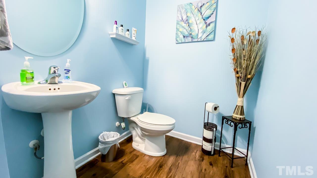 3617 Marble Ridge Lane Raleigh, NC 27610 - Photo 27 of 30 a bathroom with a sink toilet and a mirror