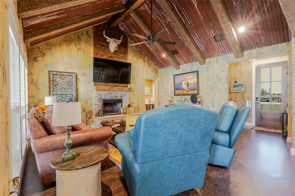 470 Wilson Bend Road Millsap, TX 76066 - Photo 8 of 39 a living room with furniture a fireplace and a flat screen tv