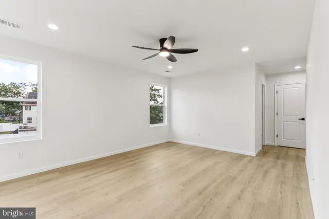 a bathroom with a sink a toilet a mirror and shower