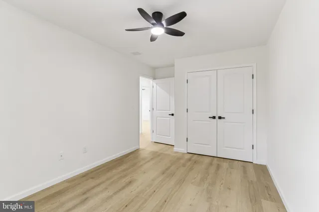 a view of a livingroom with a ceiling fan and window