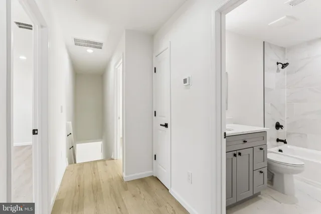 a bathroom with a shower sink and mirror