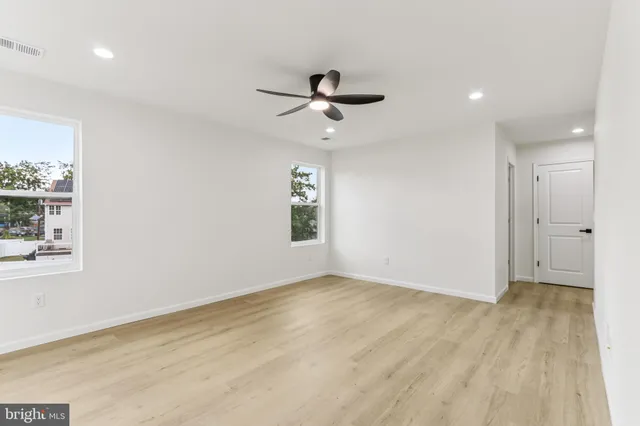 a white toilet sitting next to a white walls