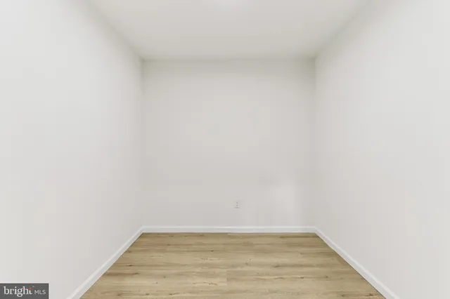 a row of palm trees in front of a house