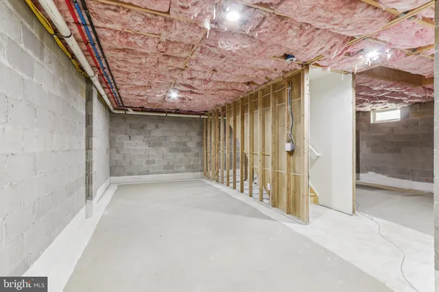 a view of a white house with a large window and large tree