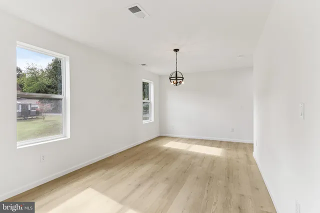 a kitchen with granite countertop a refrigerator and a stove top oven