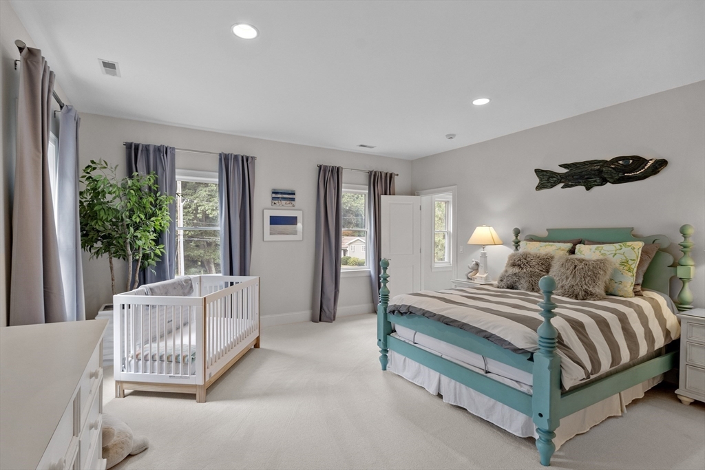 77 Revolutionary Road Concord, MA 01742 - Photo 23 of 42 a spacious bedroom with a bed and a couch