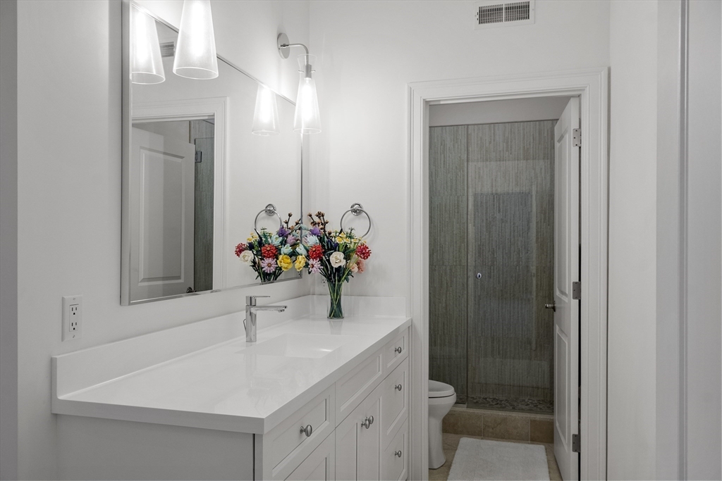 77 Revolutionary Road Concord, MA 01742 - Photo 24 of 42 a bathroom with a sink vanity and a mirror