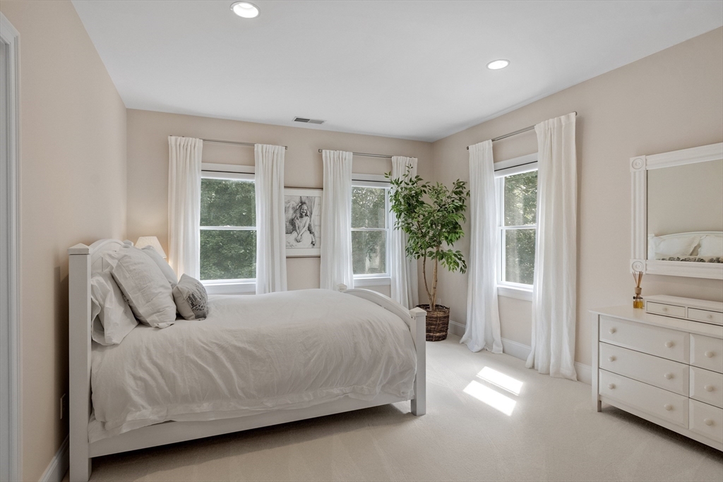 77 Revolutionary Road Concord, MA 01742 - Photo 25 of 42 a bedroom with a large bed and a window