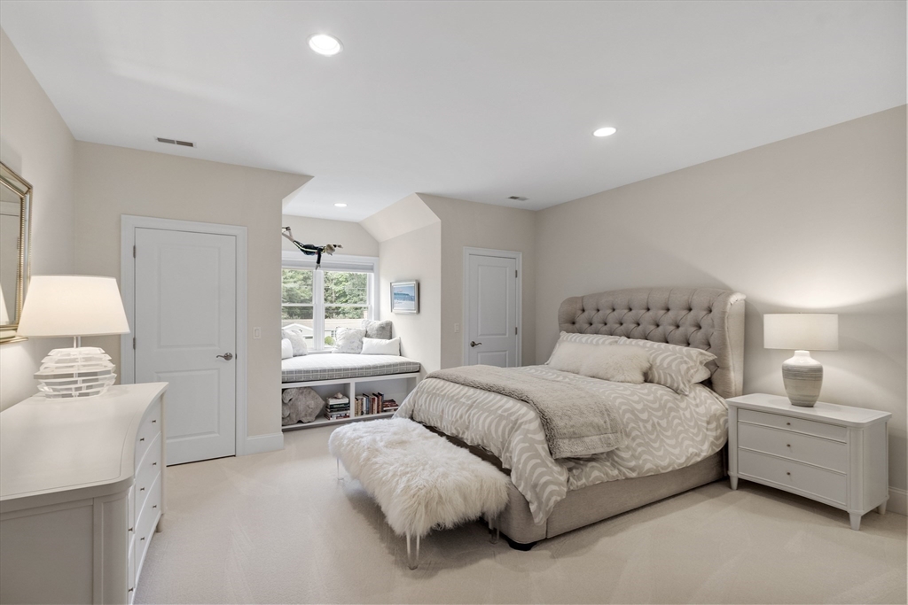 77 Revolutionary Road Concord, MA 01742 - Photo 28 of 42 a spacious bedroom with a bed and a large window